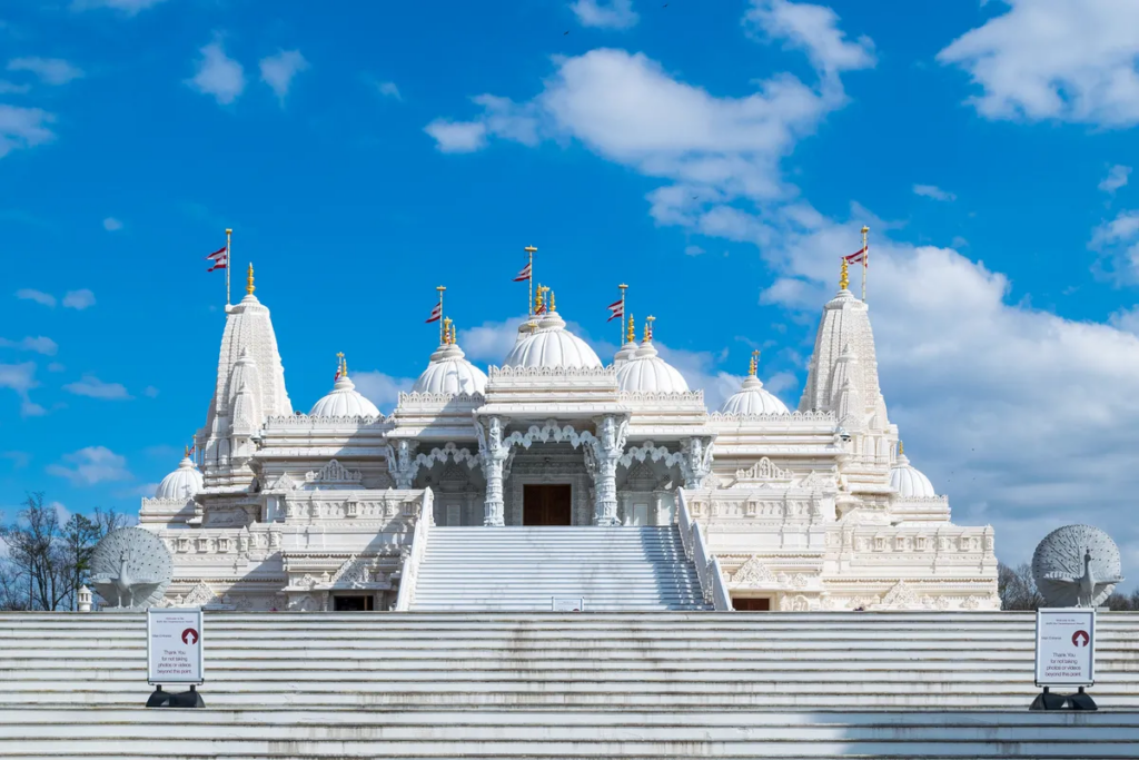 Intricate white marble architecture of BAPS Shri Swaminarayan Mandir in Lilburn, Georgia.